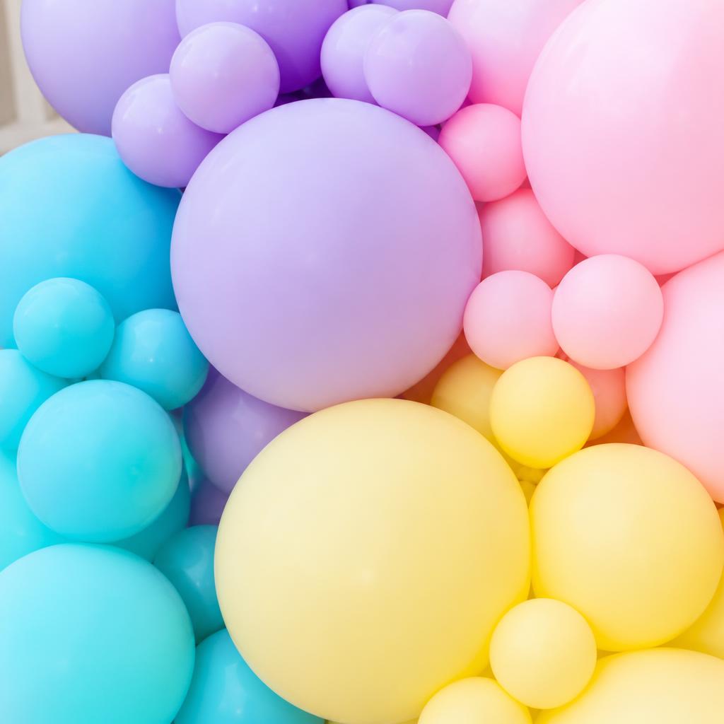 Close-up of pastel lilac, aqua, blush and butter yellow balloons